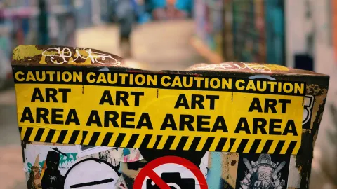 a street sign with a lot of stickers on it